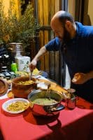 a man standing next to a table full of food