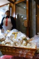 a basket of pastries in plastic bags
